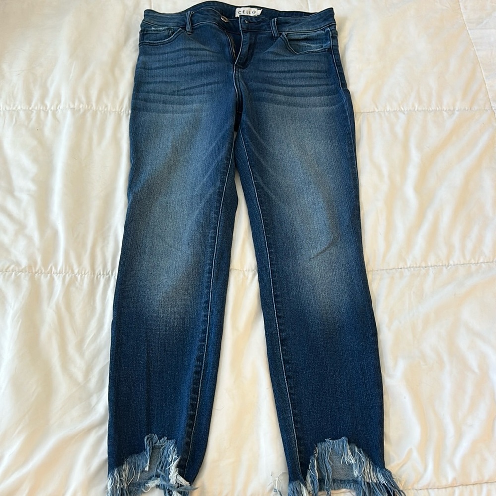 Dark blue jeans with distressed ankle